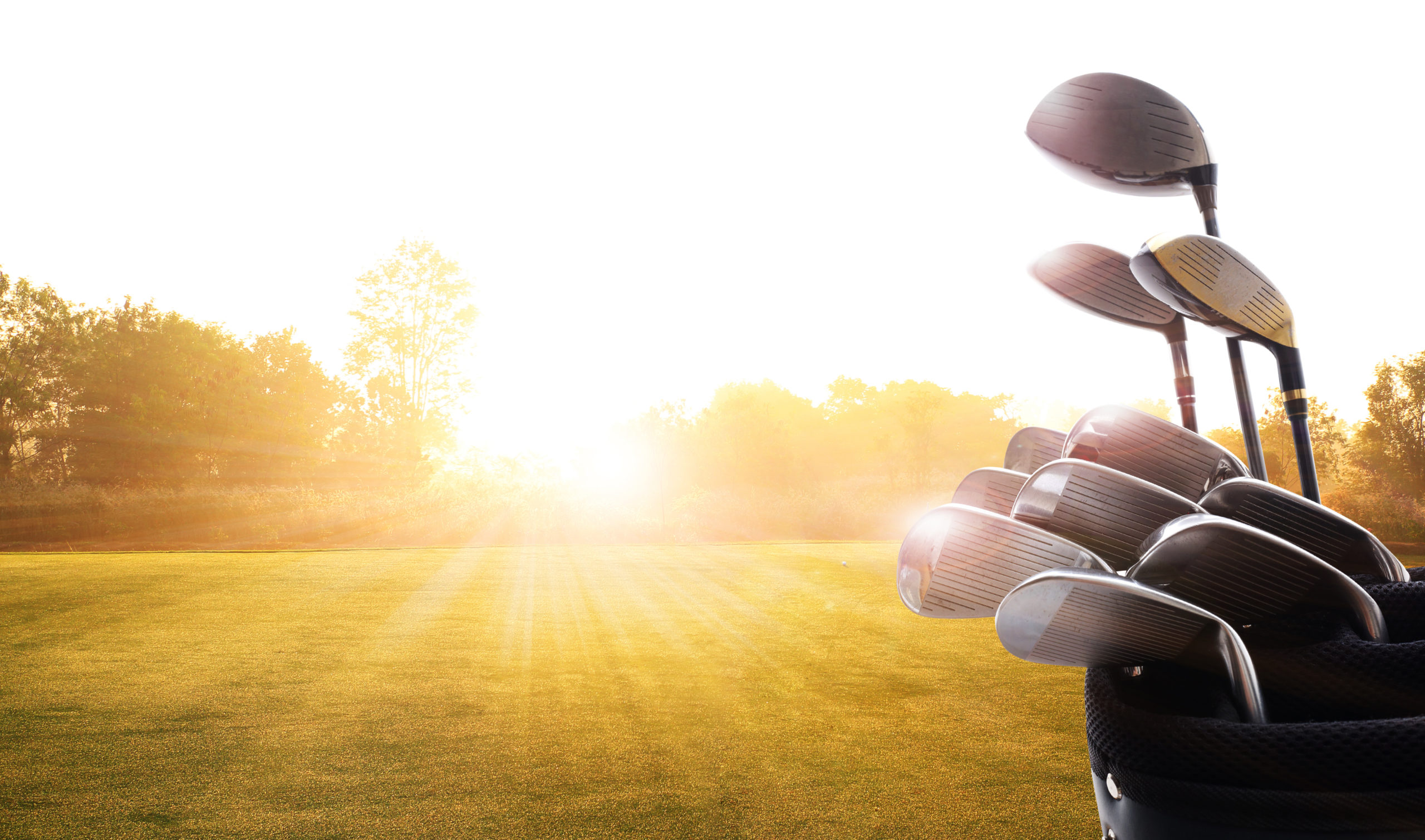 Golf clubs drivers  over beautiful golf course at the sunset, sunrise time. , morning time
