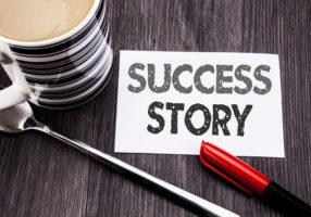 Conceptual hand writing text caption showing Success Story. Business concept for Inspiration Motivation written on sticky note paper on wooden wood background. With coffee and marker